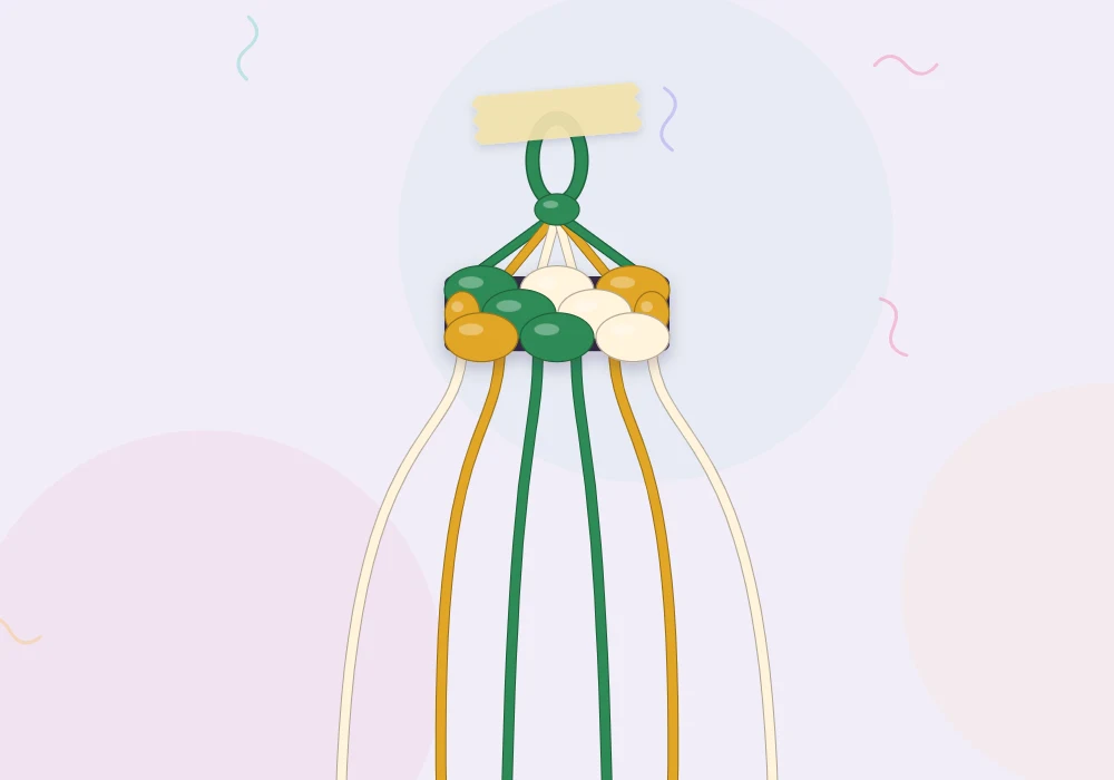 Folded strings in forest green, gold and cream forming a small loop at the top of a bracelet