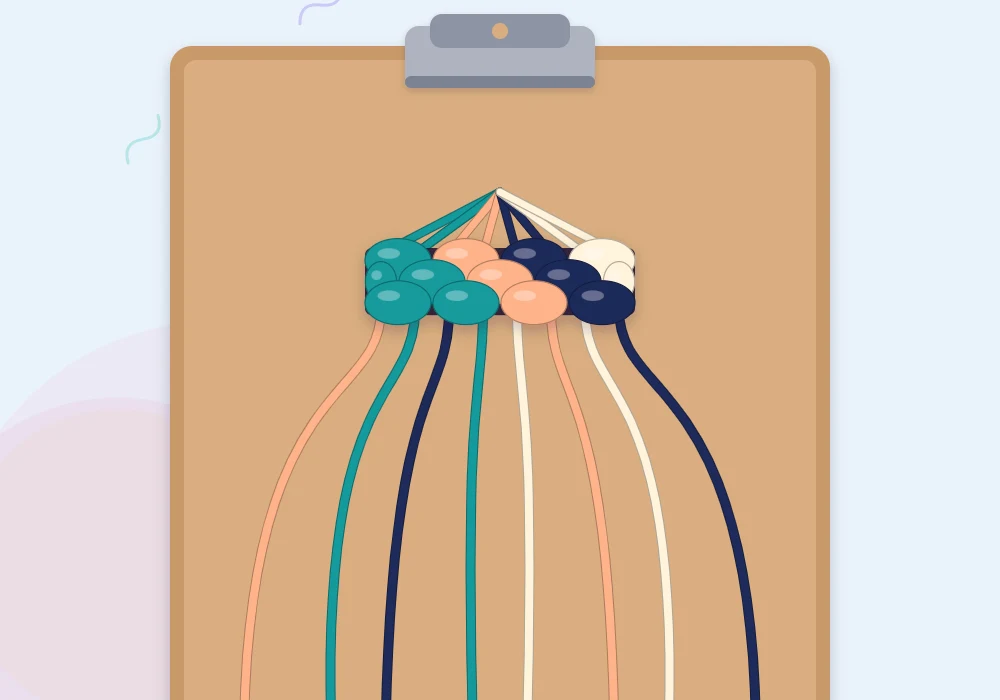 Strings in teal, peach, navy and cream held under the clip of a clipboard