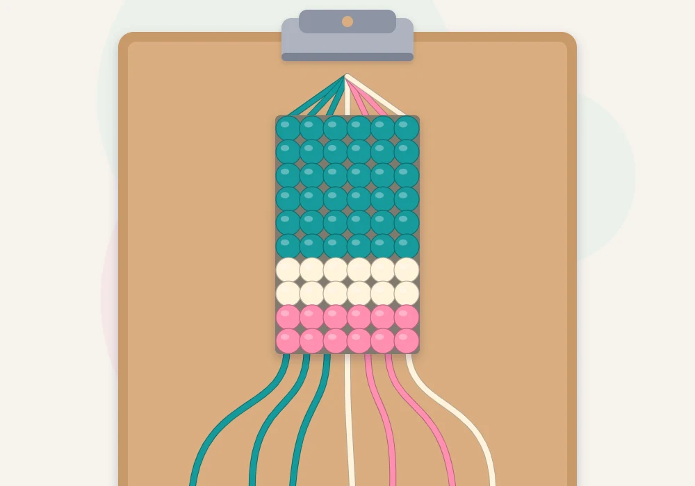A horizontal stripe bracelet in progress held by a clip, with teal, cream and rose bands and loose strings fanned out below