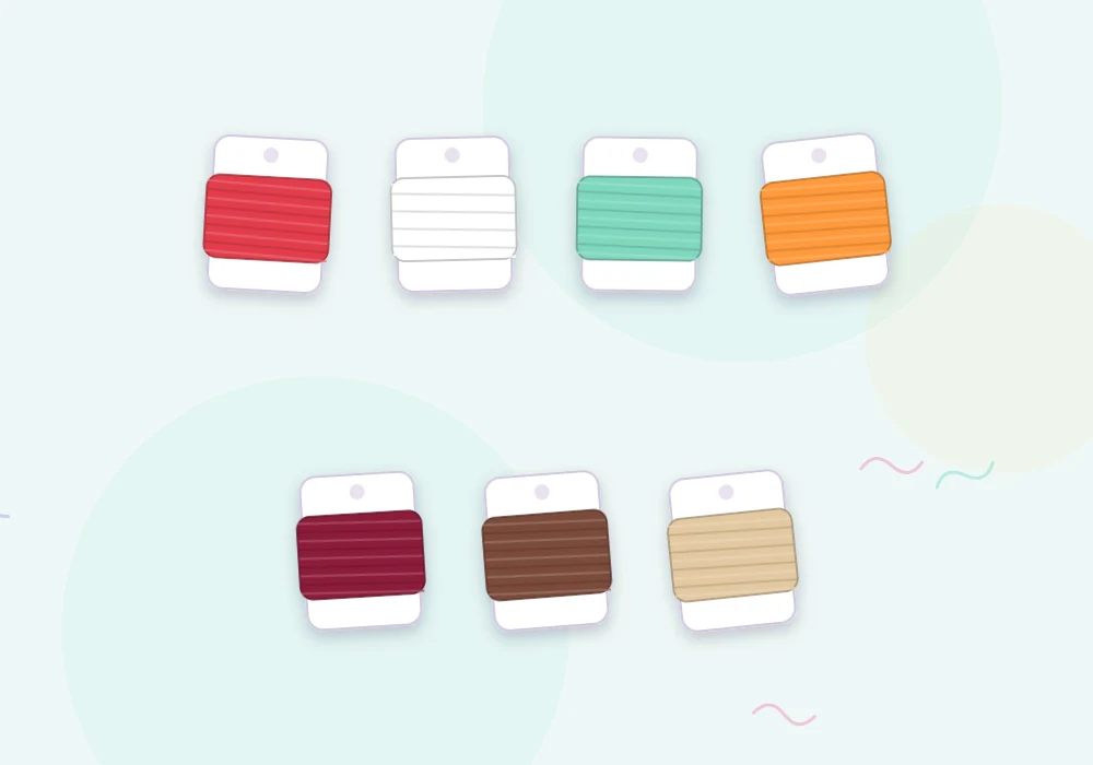 Bobbins of embroidery floss in red, white, mint, tangerine, burgundy, cocoa brown and sand